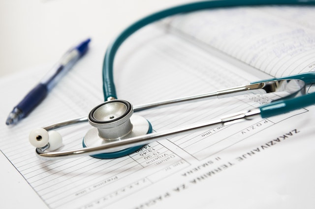 Stethoscope and pen laying on a form